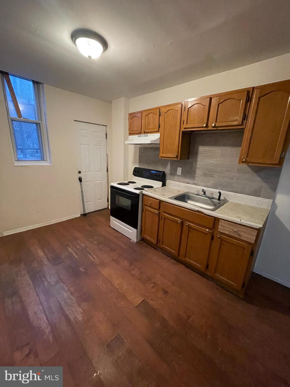 3432 Ormes Street Philadelphia, PA 19134 - Photo 10 of 10 a kitchen with stainless steel appliances granite countertop a sink stove and cabinets