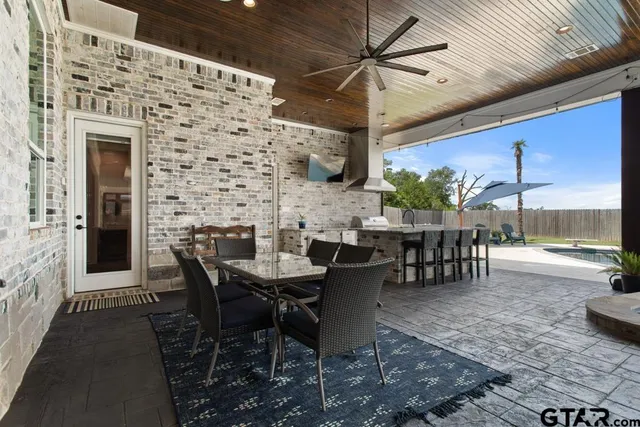a view of a patio with table and chairs and potted plants