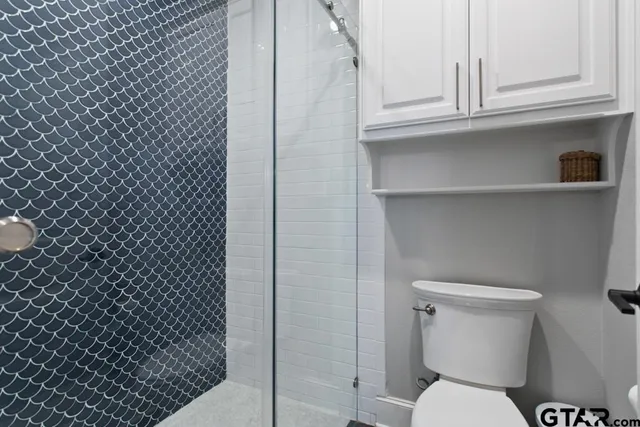 a bathroom with a granite countertop sink vanity and mirror
