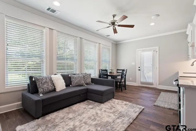 a kitchen with stainless steel appliances a stove a refrigerator sink cabinets and living room view