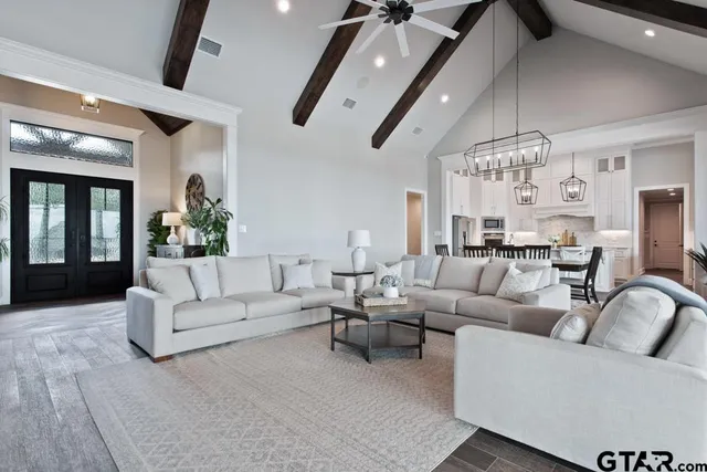 a living room with furniture ceiling fan and a rug