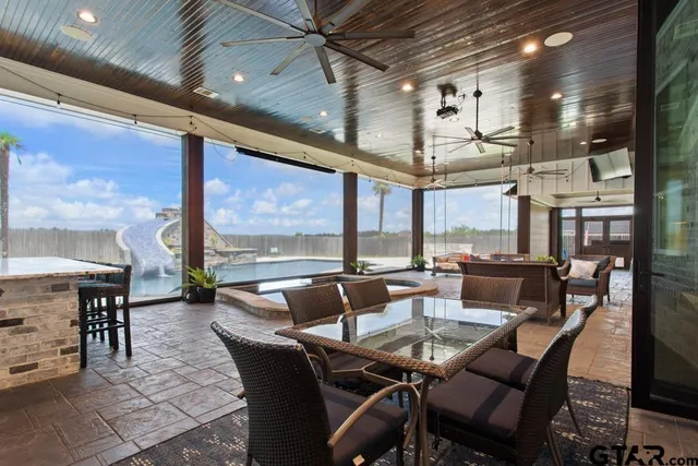 a dining room with furniture a chandelier and fireplace