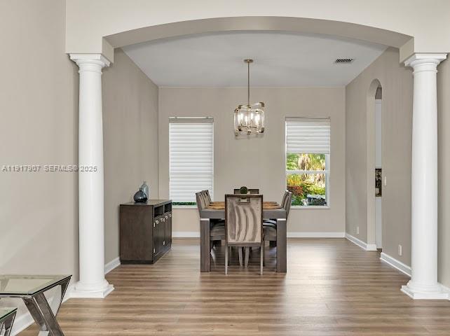 585 Southwest Yacht Basin Way Stuart, FL 34997 - Photo 27 of 61 a view of a dining room with furniture a chandelier and wooden floor
