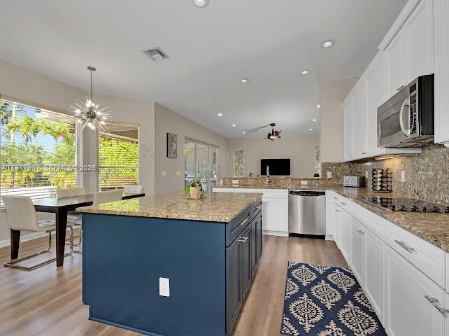 585 Southwest Yacht Basin Way Stuart, FL 34997 - Photo 30 of 61 a kitchen with a sink stove and microwave
