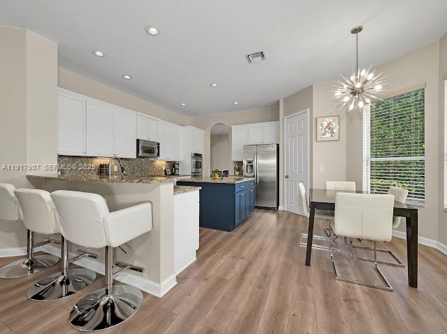 585 Southwest Yacht Basin Way Stuart, FL 34997 - Photo 34 of 61 a living room with furniture and a chandelier