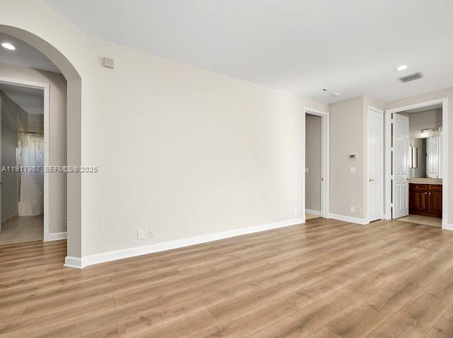 585 Southwest Yacht Basin Way Stuart, FL 34997 - Photo 41 of 61 a view of an empty room with wooden floor and a bathroom