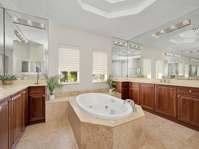 585 Southwest Yacht Basin Way Stuart, FL 34997 - Photo 56 of 61 a bathroom with a tub sink and mirror