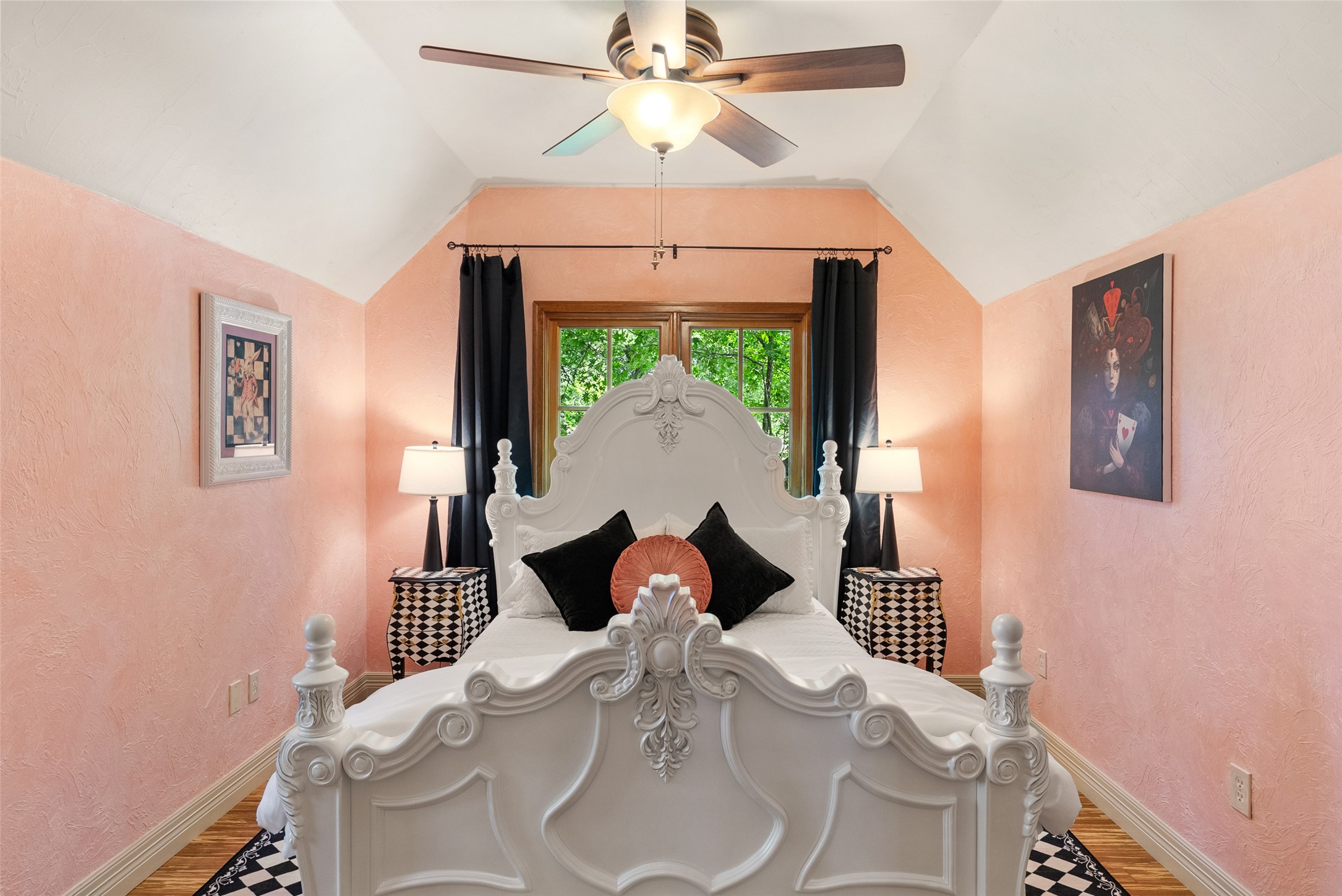 1354 The High Road Austin, TX 78746 - Photo 28 of 40 Ornate bedframe grounds a bedroom offering ample natural illumination and a ceiling fan.