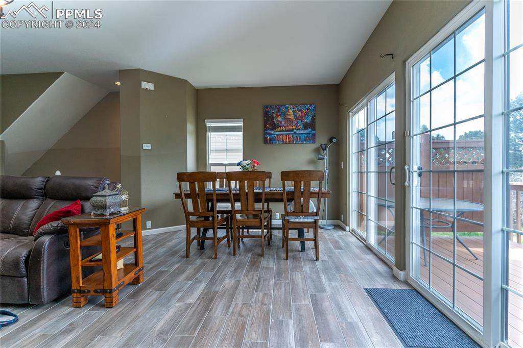 1166 Walters Point Monument, CO 80132 - Photo 4 of 21 a dining room with furniture wooden floor and a rug