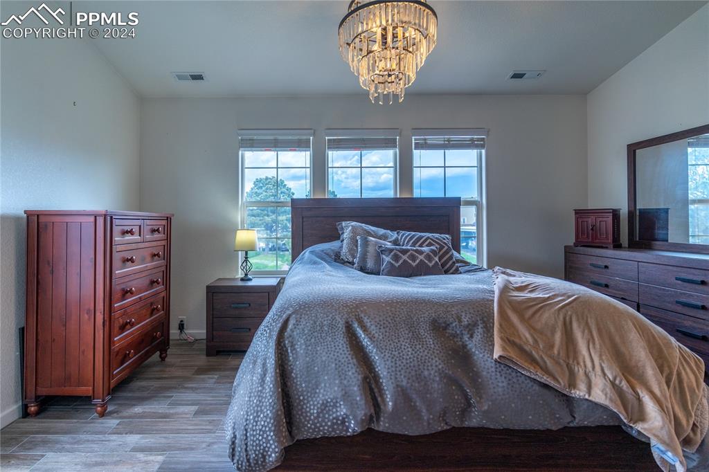 1166 Walters Point Monument, CO 80132 - Photo 8 of 21 a bedroom with a bed and a large window