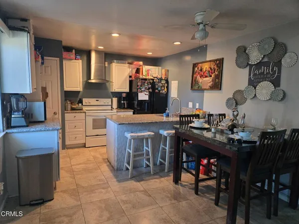 a kitchen with stainless steel appliances granite countertop a stove top oven a sink a counter top space and cabinets
