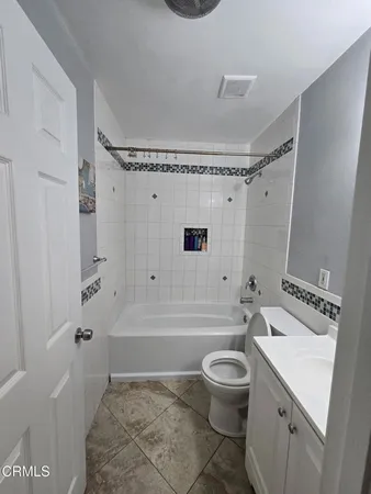a bathroom with a sink a toilet and a bathtub
