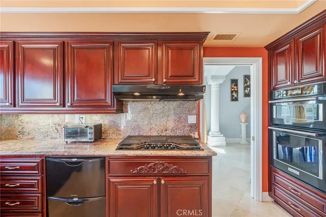 a kitchen with granite countertop stainless steel appliances and cabinets