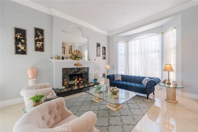 a living room with fireplace furniture and a chandelier