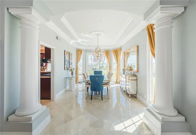 a view of a dining room with furniture and a chandelier