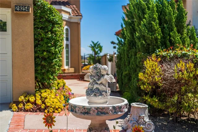 a view of a street with a yard and a wooden fence