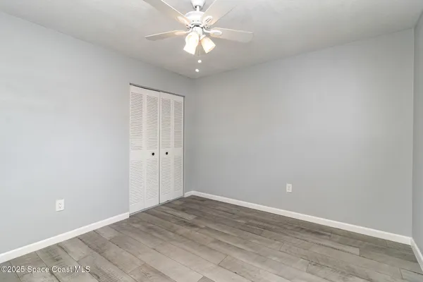 a view of an empty room with a fan