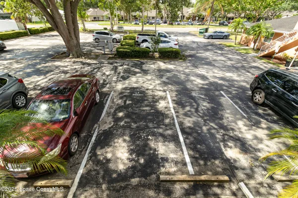 a view of a yard with cars parked
