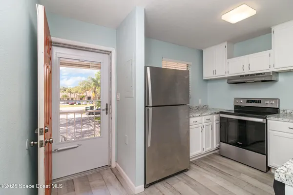 a kitchen with cabinets and stainless steel appliances
