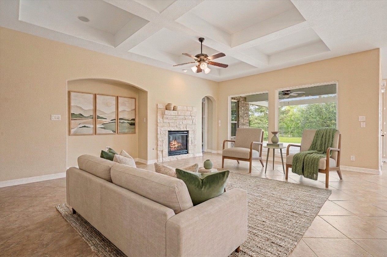 27714 Linden Ridge Lane Fulshear, TX 77441 - Photo 18 of 48 Virtually staged - The large living room boasts coffered ceilings, large picture windows with direct view to the backyard and wooded creek area, and a stone surround on the fireplace.