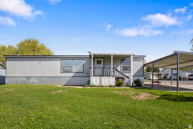 2600 North Hill Field Road, Unit 86 Layton, UT 84041 - Photo 21 of 25 Manufactured / mobile home featuring a porch and a front yard