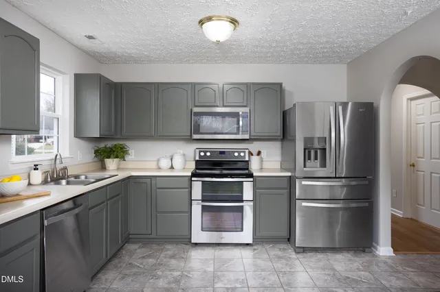 a kitchen with a stove and microwave