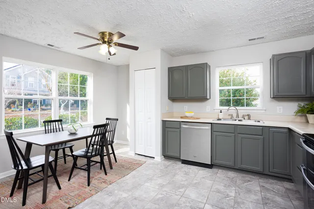 a kitchen with a sink stove top oven and cabinets