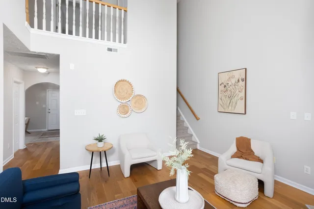 a living room with furniture a couch and wooden floor