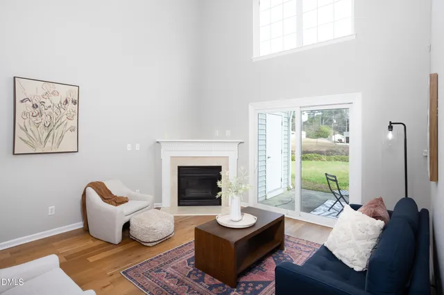 a large bed sitting in a bedroom next to a window and a lamp