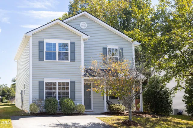a house that has a tree in front of the house