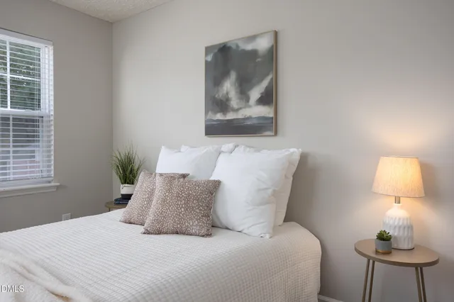 an empty room with a ceiling fan and a window
