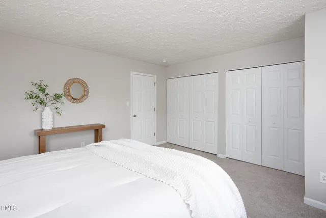 a view of a lake with couches and table and chairs with wooden floor