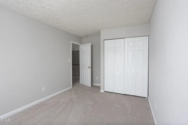 a view of a house with a yard and garage