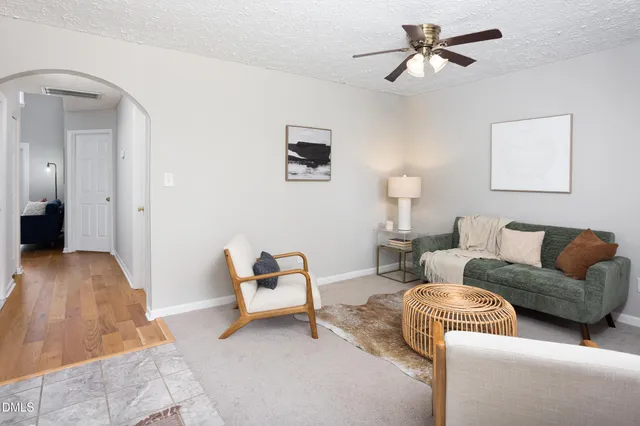 a living room with furniture and a chandelier