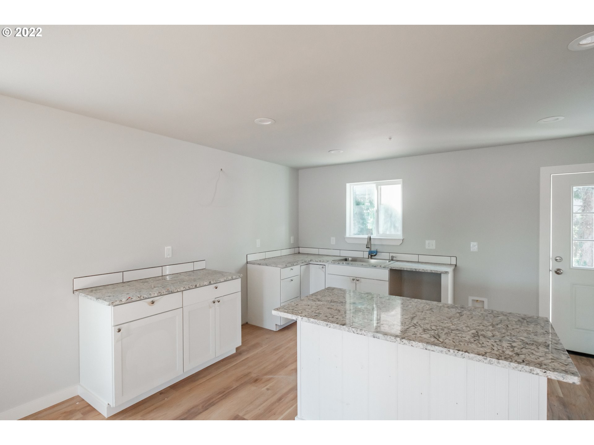 1671 Cooper Street Lebanon, OR 97355 - Photo 18 of 32 a kitchen with a sink dishwasher a stove top oven and white countertops