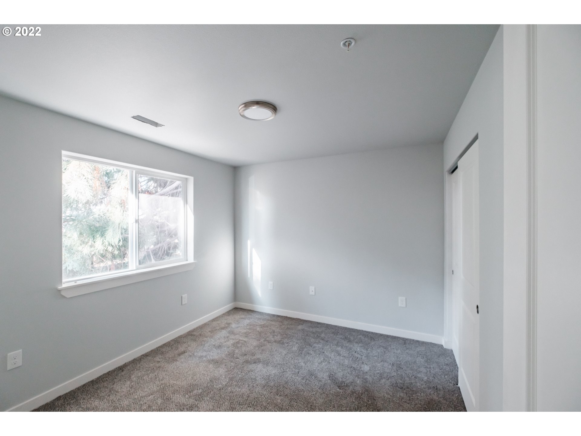 1671 Cooper Street Lebanon, OR 97355 - Photo 7 of 32 a view of an empty room with wooden floor and a window