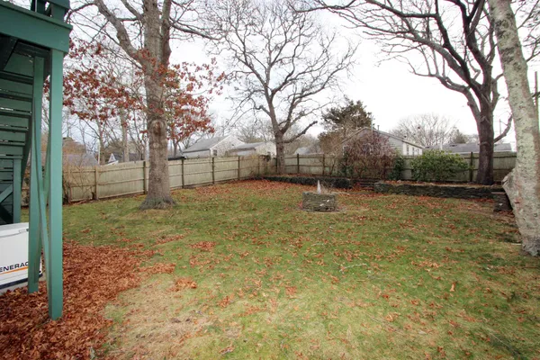 a view of a backyard with a tree