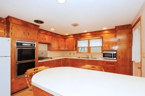 a kitchen with stainless steel appliances a stove and a refrigerator