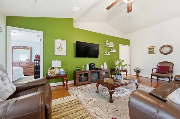 a living room with furniture and a flat screen tv