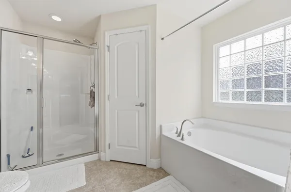 a bathroom with a bathtub and a shower