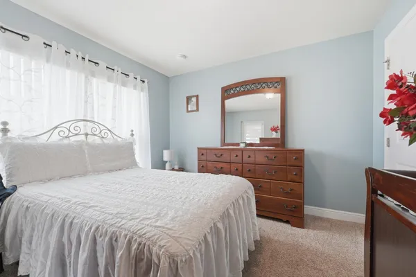 a bedroom with a bed and a mirror