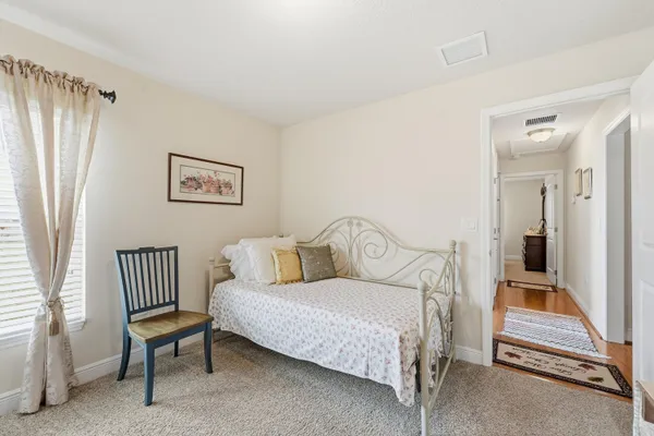 a bedroom with a bed and a couch