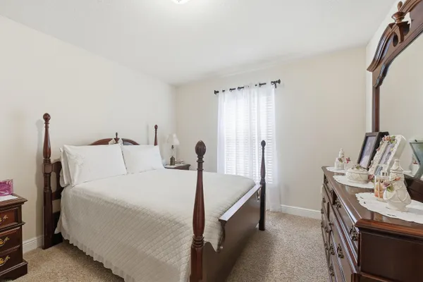 a bed room with a bed and a chair