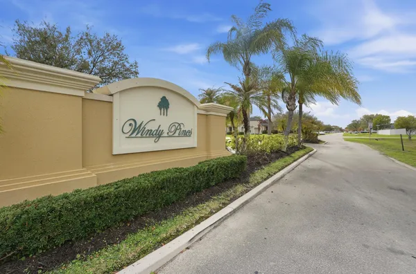a view of a entrance gate of the house and palm tree