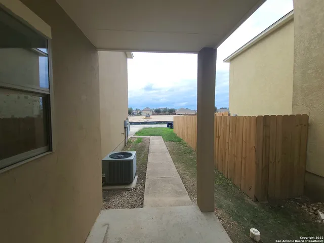 a view of a balcony with wooden floor and outdoor space