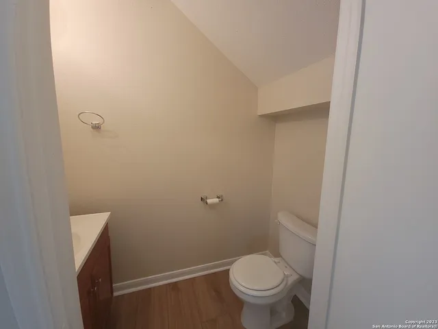 a white toilet sitting next to a shower