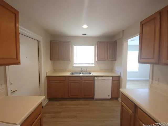 a kitchen with sink and cabinets