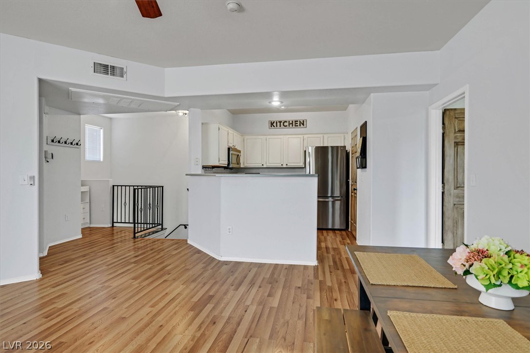 8555 West Russell Road, Unit 2069 Las Vegas, NV 89113 - Photo 27 of 27 An open floorplan seamlessly connects the well-appointed kitchen to a bright living area with rich hardwood flooring.