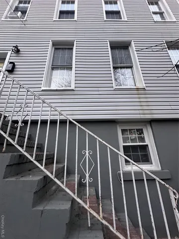 a view of a house with wooden door and a floor to ceiling window