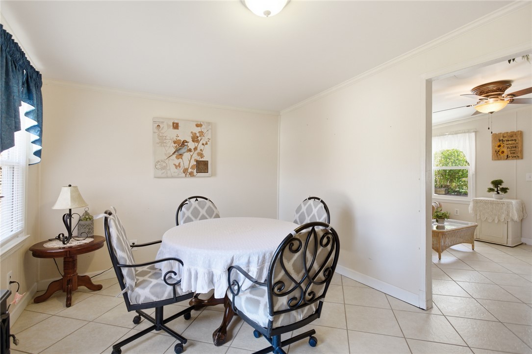 108 Hodge Street Abbeville, SC 29620 - Photo 11 of 39 A well-lit dining area features a round table, perfect for intimate gatherings.
